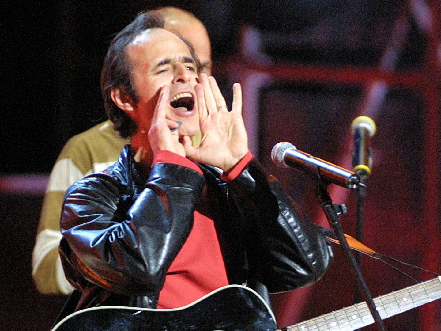 French singer Jean-Jacques Goldman jokes about an electrical failure during his performance at the NRJ music awards in Cannes January 19, 2002. - PBEAHUKVAEH